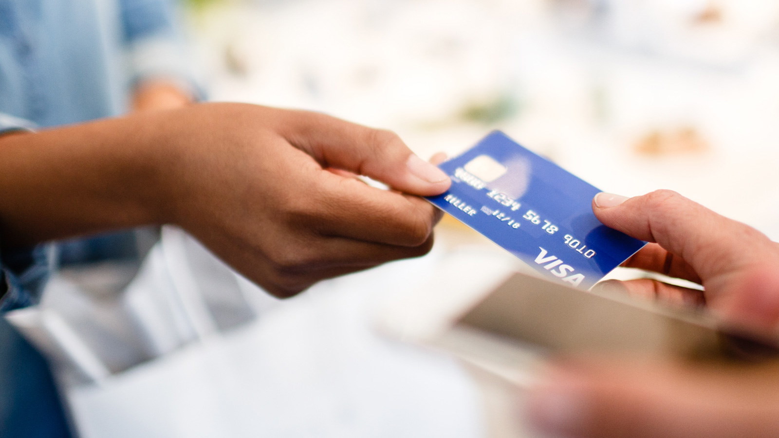 Woman passing debit card