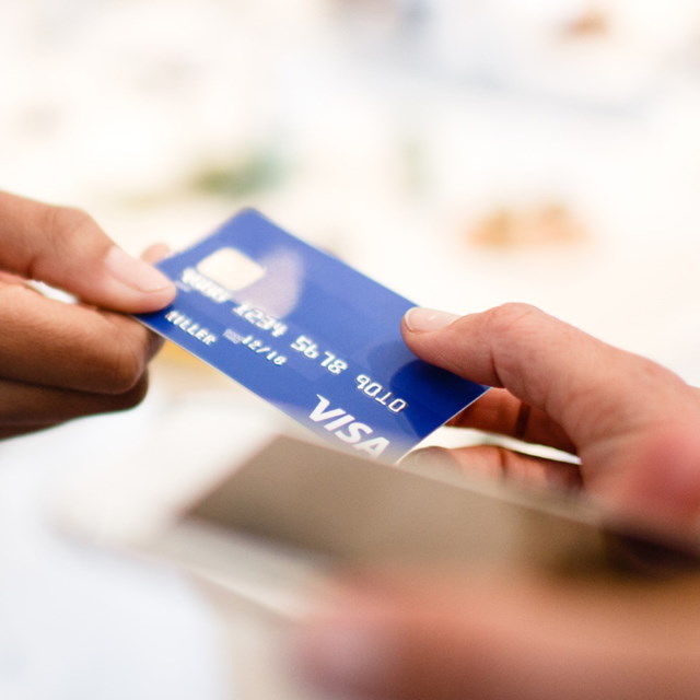 Woman passing debit card