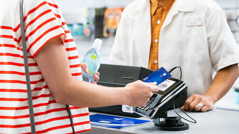 Woman paying using contactless at pharmacy