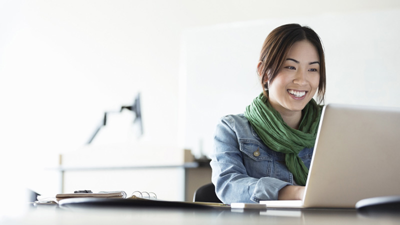 Woman checking her credit score on laptop